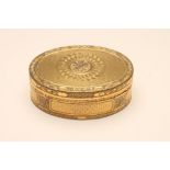 A GILT METAL SNUFF BOX, c.1800, of plain oval form, cast and chased with small panels of flowers