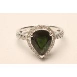 A TOURMALINE AND DIAMOND DRESS RING, the pear cut tourmaline of approximately 2cts claw set to a