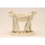 JAMES HADLEY FOR ROYAL WORCESTER- A CHINA FIGURAL FLOWER HOLDER, 1883, modelled as two children in