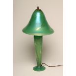 J. DITCHFIELD - a glass electric table lamp base, the green iridescent high mushroom shade on a