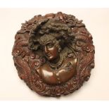 A BRONZE WALL PLAQUE, c.1900, carved in high relief as the head of a Renaissance female, unsigned,