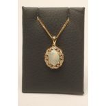AN OPAL AND DIAMOND PENDANT, the claw set oval cabochon polished opal within an open border set with