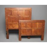 AN ADZED OAK SINGLE BEDSTEAD by Robert Thompson, of oblong multi panelled form with half penny