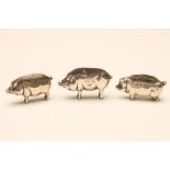 THREE SILVER NOVELTY PIG PIN CUSHIONS, two Birmingham 1906, one mark is completely rubbed, one