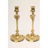 A PAIR OF FRENCH ORMOLU CANDLESTICKS stamped Maison Marnyhac, Rue de la Paix, the turned fluted