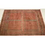 AN AFGHAN RUG, modern, the quartered field with candelabra motifs, horizontal spires with trees,