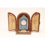 A CONTINENTAL MINIATURE CARRIAGE CLOCK, indistinctly marked, the circular white enamel dial with