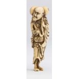 A JAPANESE IVORY NETSUKE, 18th century, carved as Sennin Chokwaro, standing and holding a gourd with