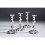 A SET OF FOUR GEORGE III SILVER CANDLESTICKS, maker Jonathan Gould, London 1742, with scroll cast