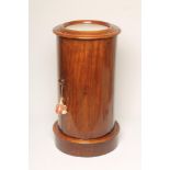 A VICTORIAN MAHOGANY POT CUPBOARD of cylindrical form, the inset white marble top within a moulded