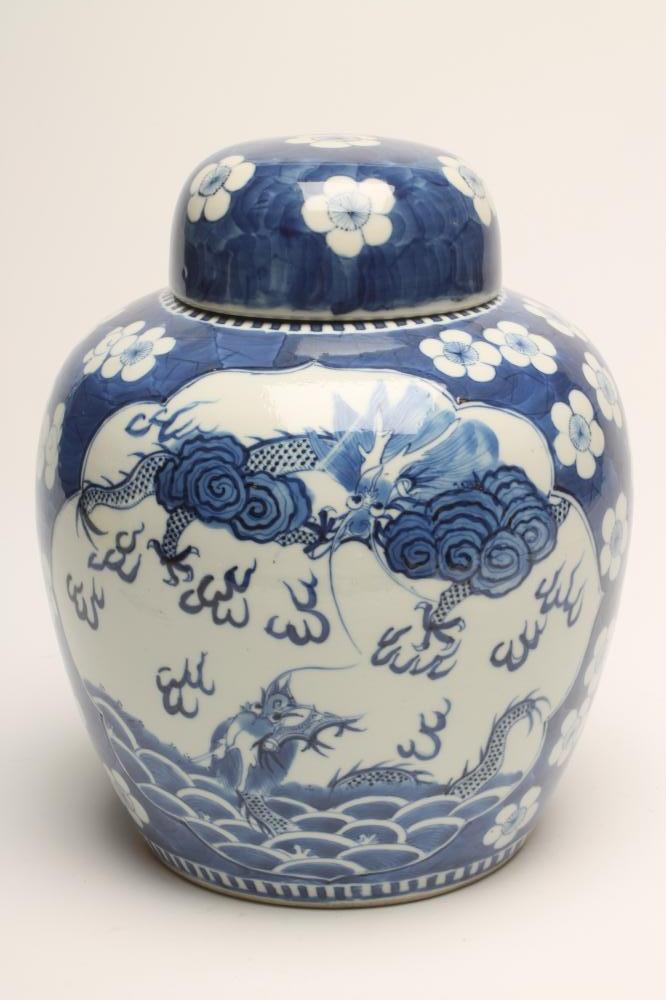 A CHINESE PORCELAIN JAR AND COVER of ovoid form, painted in underglaze blue with two panels, one