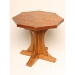 AN ADZED OAK COFFEE TABLE in the Robert Thompson style, the octagonal top with mildly concave sides,