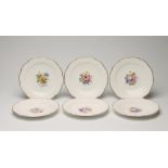 A SET OF SIX ENGLISH PORCELAIN PLATES, of shaped circular form with ozier moulded rims, centrally