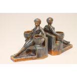 A PAIR OF ART DECO CONTINENTAL EARTHENWARE FIGURAL BOOKENDS, possibly Belgian, each modelled as a