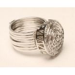 AN UNUSUAL DIAMOND METAMORPHIC RING/BRACELET, the 18kt white gold concentric circular panel pave set