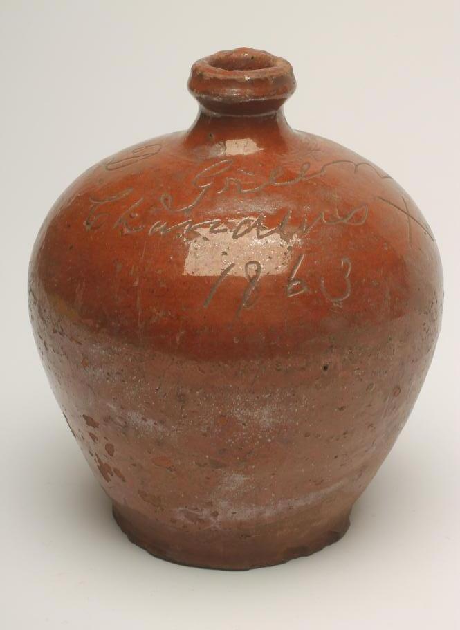 A VICTORIAN DOCUMENTARY GLAZED TERRACOTTA FLAGON, of rounded form, incised "D. Green/Chandler's X/