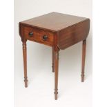 A REGENCY MAHOGANY WORK TABLE of rounded oblong form with ebony stringing, moulded edged top with