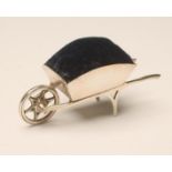 AN EDWARDIAN SILVER NOVELTY WHEELBARROW PIN CUSHION, maker Miller Bros., Birmingham 1908, with