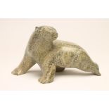 AN INUIT GREEN STEATITE POLAR BEAR. modern, carved and polished and walking with its head turned