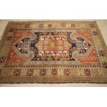 A CAUCASIAN RUG, the red field with large gul in sky blue, navy blue and ivory, with a