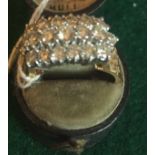 Diamond ring comprising 19 diamonds claw set in three rows on 18ct bark effect shank, size O.