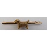 Bar brooch with 15ct terrier dog mounted on 9ct pin 7.6 gm total