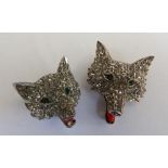 A pair of pave set diamond fox head brooches with ruby eyes the larger 3cm high