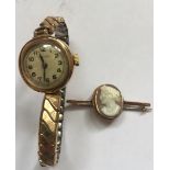 Ladies 9ct gold cased wristwatch on rolled gold bracelet together with a cameo brooch in yellow