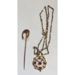 Nine carat gold pendant set with garnets on yellow metal chain together with a yellow metal