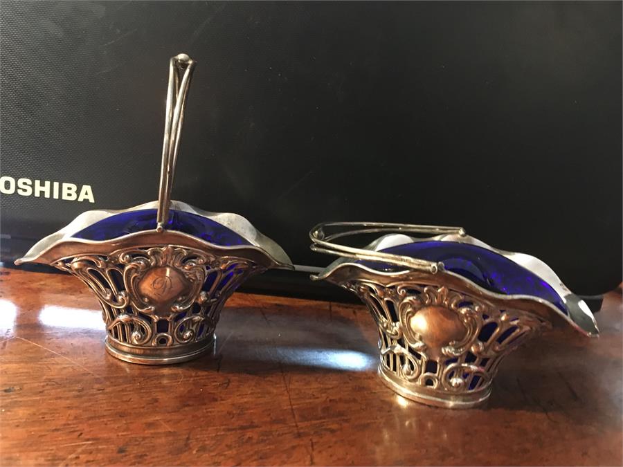 Pair pierced silver swing handle baskets.