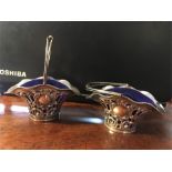 Pair pierced silver swing handle baskets.