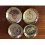 Four dishes marked silver with Indian Rupee coins inset