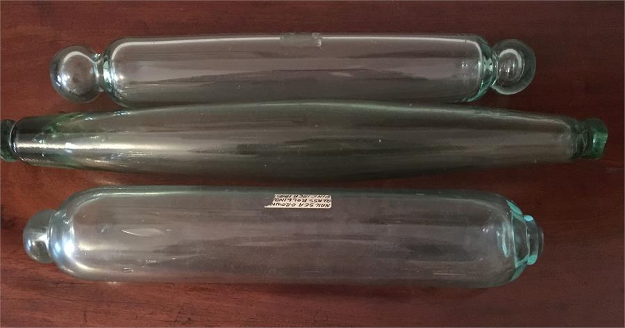 Three clear glass rolling pins