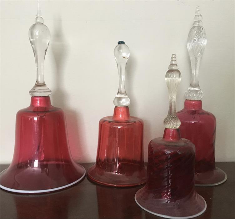 Four cranberry glass bells with contrasting edge