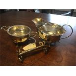 Silver creamer, tea strainer and stand and two plated knife rests