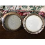 Two circular silver photo frames