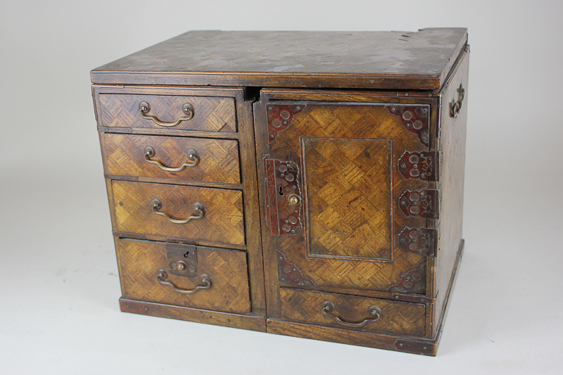 A Japanese marquetry inlaid table top collector's cabinet with arrangement of small drawers and