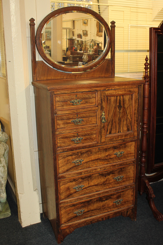 A Maple & Co olive wood dressing chest with oval mirror surmount above three short drawers and