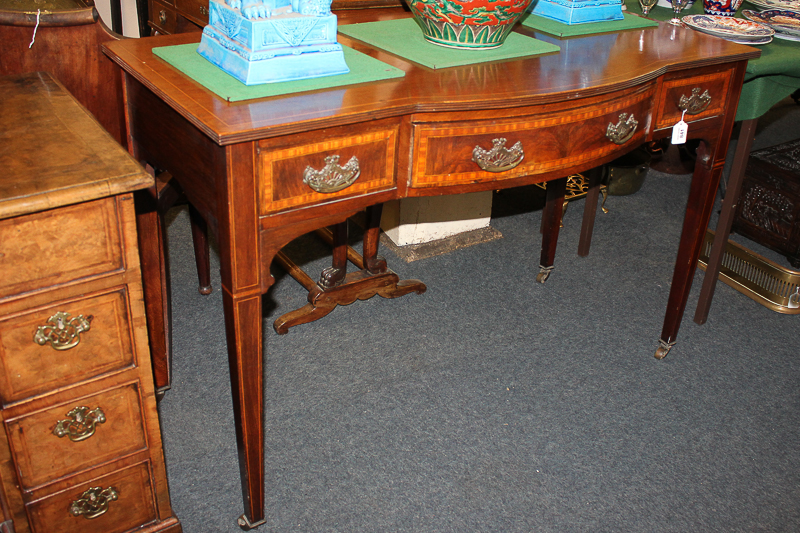 An Edwardian inlaid mahogany side table with central bow front drawer and two other drawers, each