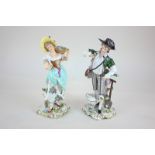 A pair of Sitzendorf porcelain figures of a male gardener and a female flower seller, in 18th