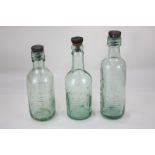 Three glass bottles, including Pinks and Chitty of Chichester