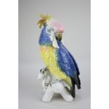 A Karl Ens large porcelain model of a parrot with brightly coloured feathers, 33cm high