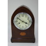 An Edwardian lancet mantel clock, the inlaid mahogany case with bats wing design and arched form,