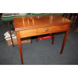 An Edwardian mahogany tea table with rectangular folding top and small dummy drawer, on square