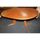 A Gudme Mobelfabrik Danish teak oval extending dining table on two splayed supports, with extra