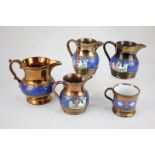 A collection of four bronze lustre ware jugs, tallest 12cm, and a small lustre ware mug