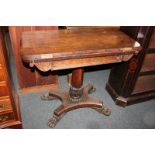 A 19th century rosewood card table with fold-over rectangular top, on carved baluster stem with