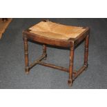 A rectangular oak stool with rush drop-in seat, on turned legs with low supporting stretcher, 50cm