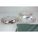 A pair of silver plated oval entree dishes with replacement clear glass liners, in Harrods green