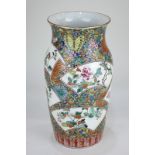 A Japanese porcelain vase with panel decoration depicting birds and flowers, on polychrome and